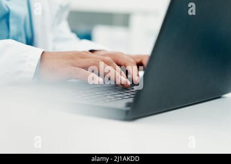 Effective research to find an effective treatment. Cropped shot of a scientist using a laptop while working in a laboratory. Stock Photo