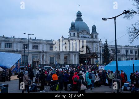 A crowd of refugees is seen outside the Lviv-Holovnyi railway station waiting to get inside and board a train to flee the country to in Lviv, Ukraine Stock Photo