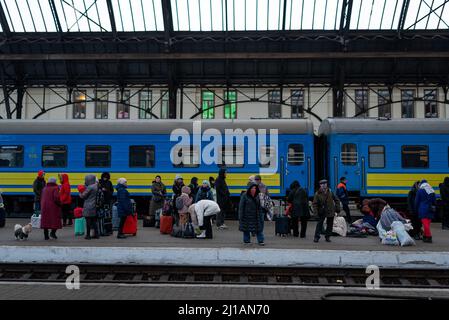 Refugees with luggage and suitcases are seen on a platform at the Lviv-Holovnyi railway station waiting to board a train to flee the country to in Lvi Stock Photo