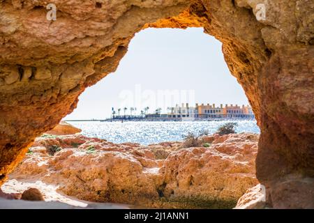 Beautiful sandstone arch with the view from Ferragudo to marina in Portimao, Algarve, Portugal Stock Photo
