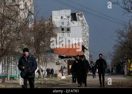 Mariupol, Ukraine. 23rd Mar, 2022. People pass by damaged buildings in Mariupol, Ukraine, March 23, 2022. Credit: Victor/Xinhua/Alamy Live News Stock Photo