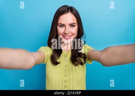 Photo of cute millennial brunette curly hairdo do selfie wear green top isolated on blue color background Stock Photo