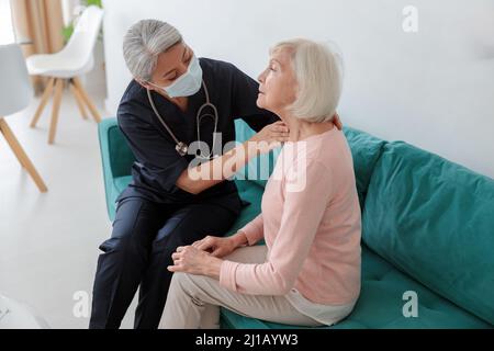 Medical practitioner searching for neck problems in a patient Stock Photo