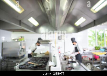 Blurred of Restaurant Chef cook preparing sea food in open kitchen at restaurant.  Modern kitchen. Stock Photo