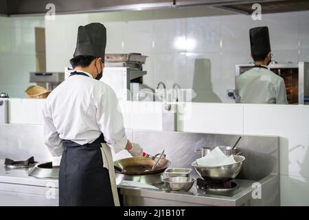 Two chefs prepare meals in the restaurant's kitchen. Modern kitchen. Stock Photo
