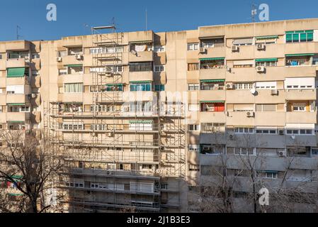 Facade of a building with metal scaffolding to carry out works Stock Photo