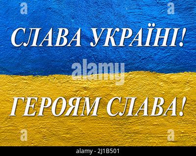 slogan Glory to Ukraine, Glory to Heroes in Ukrainian on flag painted on wall Stock Photo