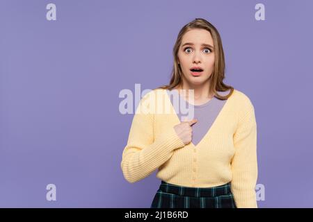 shocked young woman pointing at herself isolated on purple Stock Photo