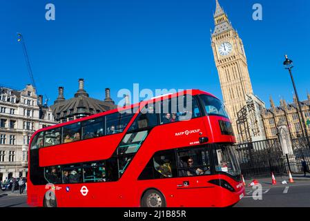 Recently uncovered restored Elizabeth Tower, Big Ben, of the Palace of Westminster, London, UK, with a red London bus passing. RATP Group bus Stock Photo