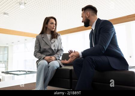 a lawyer communicates with his client before starting a court case Stock Photo