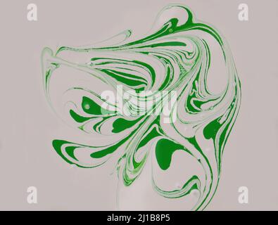 Stains of green paint on a beige background. Drops of green paint are mixed in beige paint. Stock Photo