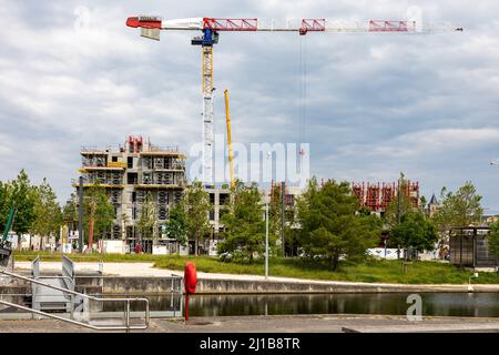 CRANE AND BUILDING UNDER CONSTRUCTION, THE CITY BEING BUILT UP, PENINSULA OF CAEN, CALVADOS, NORMANDY, FRANCE Stock Photo