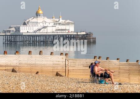 Eastbourne Beach, East Sussex, UK. 24th March, 2022. UK Weather. Sunbathers soak up the sunshine on Eastbourne Beach, East Sussex, UK Credit: reppans/Alamy Live News Stock Photo