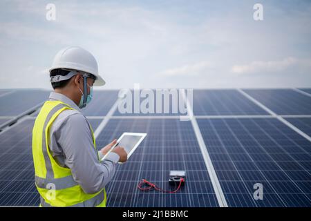 Young engineer working in the power station solar panel Stock Photo