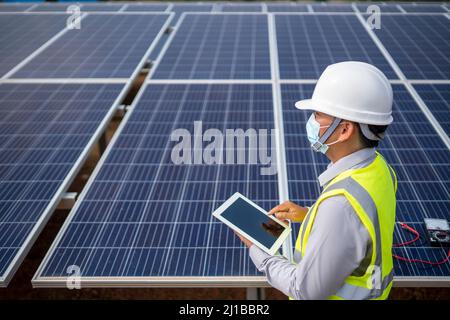 Electrical Engineering Examines Solar Panels in Renewable Energy Generation Stock Photo