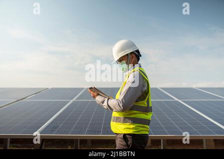 Engineers working to power solar panel renewable power plants in Thailand. Stock Photo