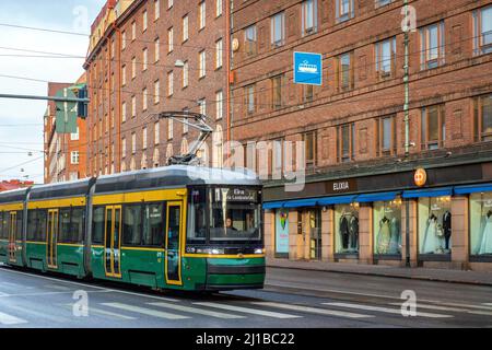 TRAMWAY IN FRONT OF THE RED BRICK BUILDINGS TYPICAL OF FINNISH ARCHITECTURE, HELSINKI, FINLAND, EUROPE Stock Photo