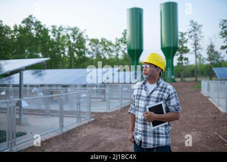 Young technician solar panel power station in the farmland Stock Photo