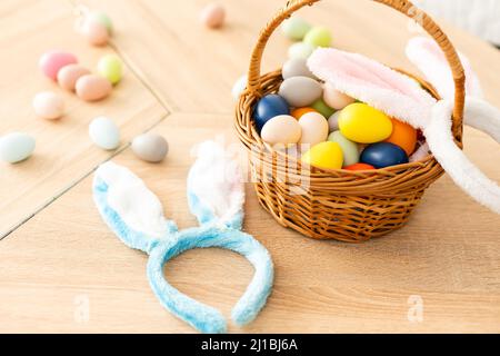 Easter concept. Eggs, Bunny's ears on festive Easter table background top-down copy space Stock Photo