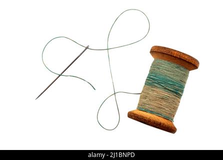 Old retro needle and thread on a white background. Spool of colored threads isolate Stock Photo