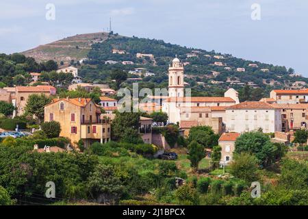 Piana, South Corsica, France. Corsican town view, old stone houses with red tile roofs with mountains on a background Stock Photo