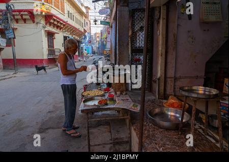 Jodhpur, Rajasthan, India - October 21st, 2019 : Man preparing breakfast in the morning for sale, using gas stove and making fried vadas, fast food. Stock Photo