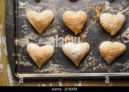 https://l450v.alamy.com/450v/2j1bxrx/puff-pastry-heart-shaped-cookies-on-baking-sheet-top-view-baking-valentines-day-homemade-dessert-2j1bxrx.jpg