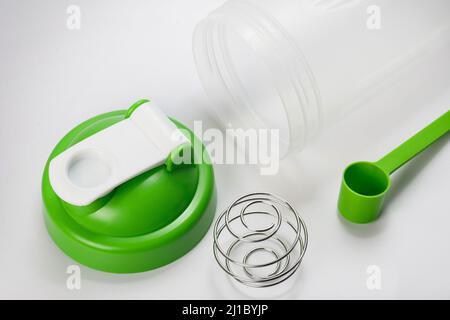Green protein shaker and scoop on white Stock Photo