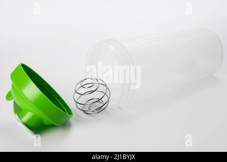 Green protein shaker with mixing ball on white Stock Photo