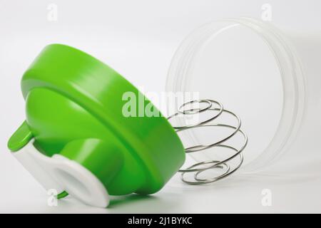 Green protein shaker with mixing ball on white Stock Photo