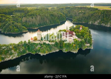 Panoramic view of Zvikov Castle on the hill with trees surrounded by river Vltava and Otava in South Bohemia region in Czech Republic. Pine or spruce forest on the background  Stock Photo