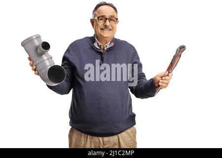 Portrait of a confused mature man holding a plastic pipe and pliers isolated on white background Stock Photo