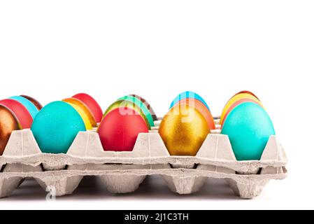 Close-up of rows of colored Easter eggs in a cardboard box. Copy space. Stock Photo