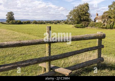 A stile on a public footpath on the flat Severn Vale beside the River Severn at Blue Boys Farm, Rodley, Gloucestershire, England UK Stock Photo
