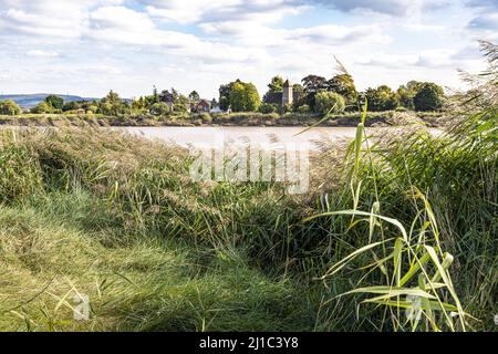 Looking across the River Severn at St Peters Church in the village of Upper Framilode from Rodley, Gloucestershire, England UK Stock Photo