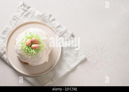 Easter cake or kulich decorated nest with pink eggs on white background. Space for text. View from above. Stock Photo