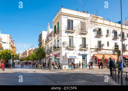 A busy intersection off of the main pedestrian street through the Triana business district along the Guadalquivir River in Seville, Spain. Stock Photo