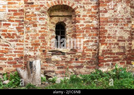 Window with iron bars in a niche of an old red brick wall. From the Window of the World series. Stock Photo