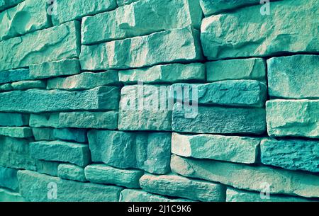 Pop art surreal style turquoise blue stonewall in sunlight Stock Photo