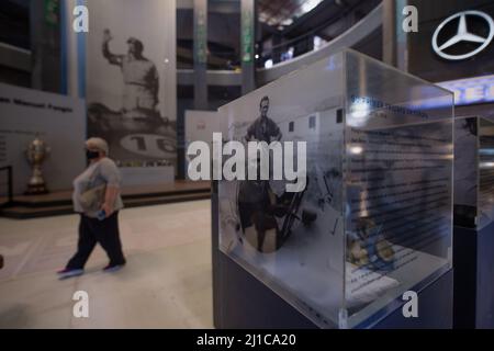 Balcarce, Argentina. 12th Mar, 2022. Visitors walk past pictures of the late Formula 1 driver Juan Manuel Fangio at the museum honoring the racing driver in his native city. The Argentine won five world championship titles (1951, 54-57). With the Mercedes 'Silver Arrow' the Fangio won the Formula 1 World Championship in 1955. Credit: Florencia Martin/dpa/Alamy Live News Stock Photo