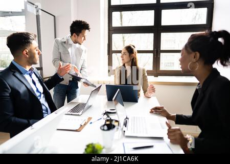 Diverse Bored Meeting Training Presentation In Office Stock Photo