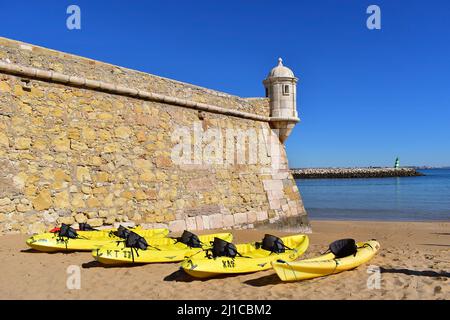 Yellow kayaks on the beach ready for an excursion out on the ocean, Lagos fortress, Algarve, Portugal, Europe Stock Photo