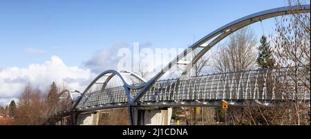 Pedestrian bridge across Trans Canada Highway in modern city suburbs Stock Photo