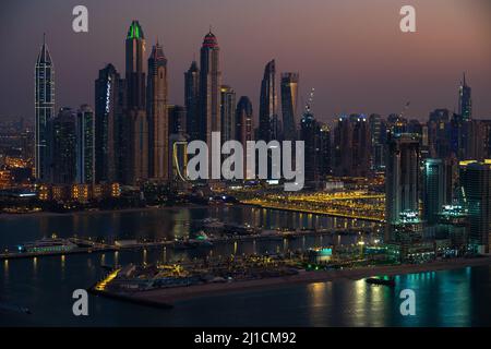 Dubai, UAE - Dec 05 2021: Aerial view of the skyscrapers and port of Dubai Marina, Dubai sunset cityscape wallpaper Stock Photo