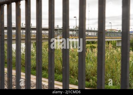 The Gateway International Bridge between Brownsville, Texas and Matamoros, Mexico, as seen through the border wall.  Viewed from Texas side of the wal Stock Photo