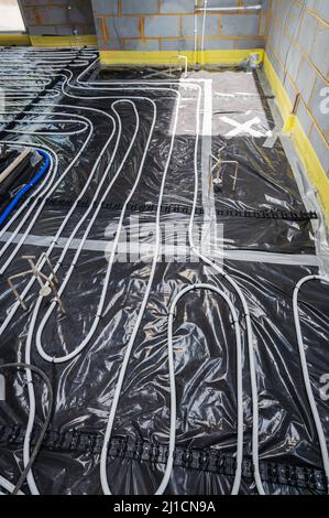 Installation of underfloor heating in residential property Stock Photo