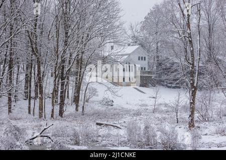 Large home in snow covered landscape Stock Photo