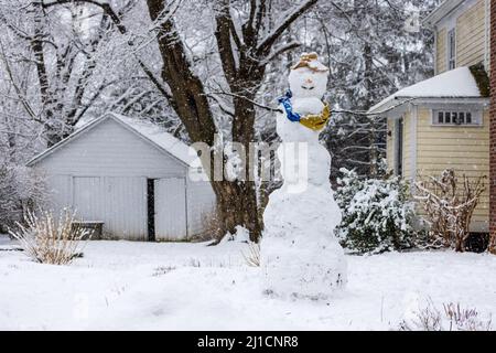 Giant odd snowman in suburban front yard  Stock Photo