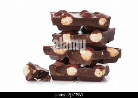 Stack of dark chocolate pieces with nuts isolated on a white background Stock Photo