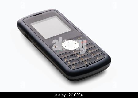 Old push-button mobile phone isolated on a white background with shadows Stock Photo